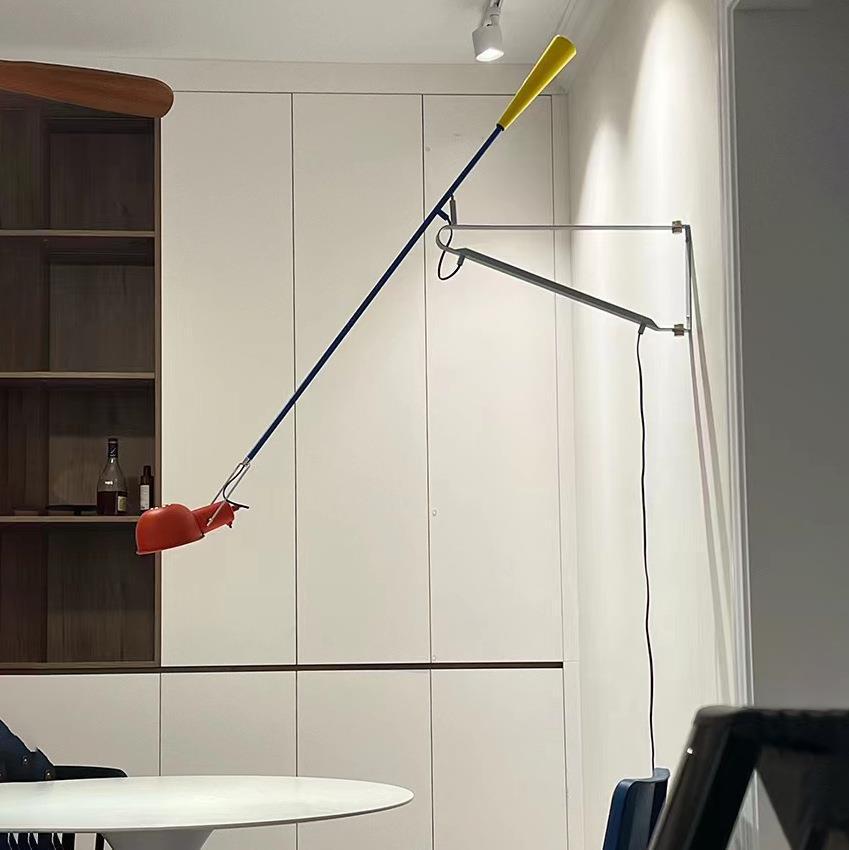 Red and yellow adjustable-arm wall light