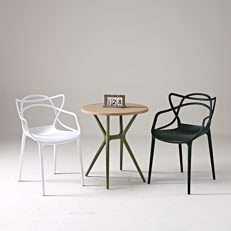 White and black chairs with sculptural open backs