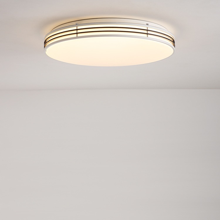 Round ceiling light with warm metallic rim