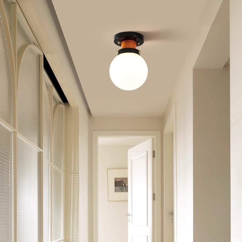 Globe ceiling light with orange and black mount