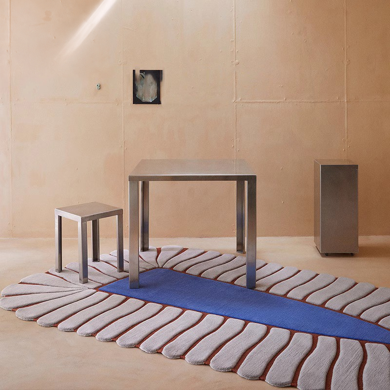 Cream and blue irregular rug in a room setting